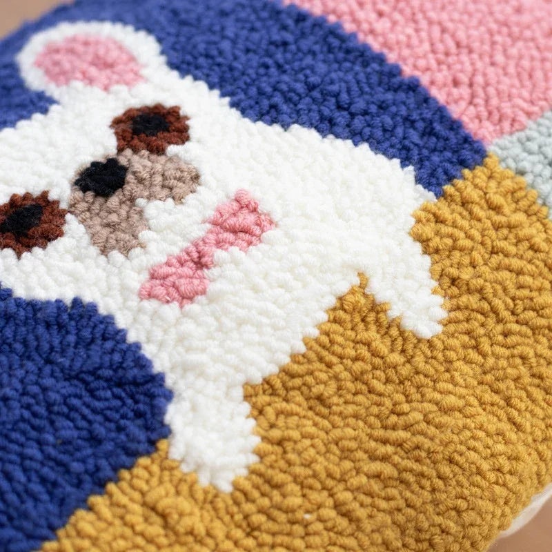Close-up of a colorful tufted textured pillow featuring a white animal face design.