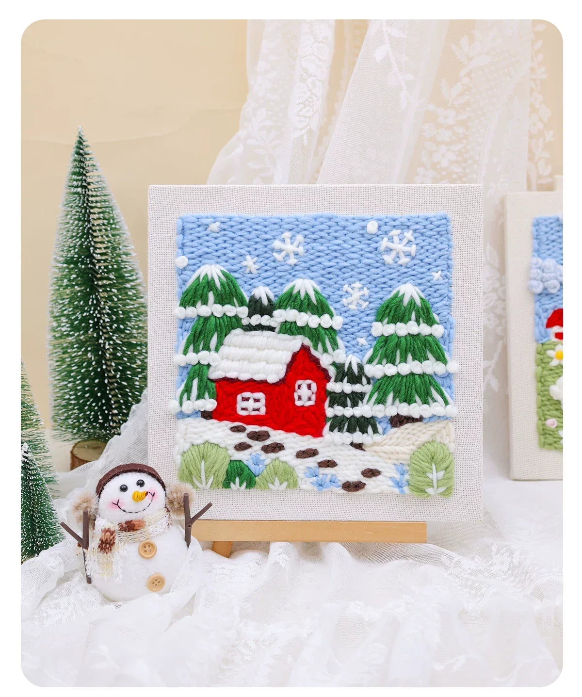 DIY punch needle embroidery kit featuring a red house and snowy winter landscape scene.