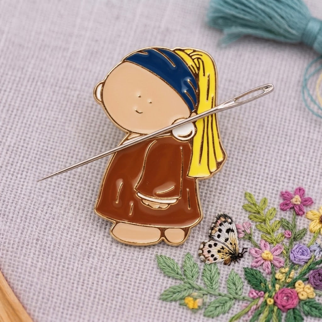 Cute Girl Magnetic Needle Minder by Calivra Craft holding a sewing needle on fabric