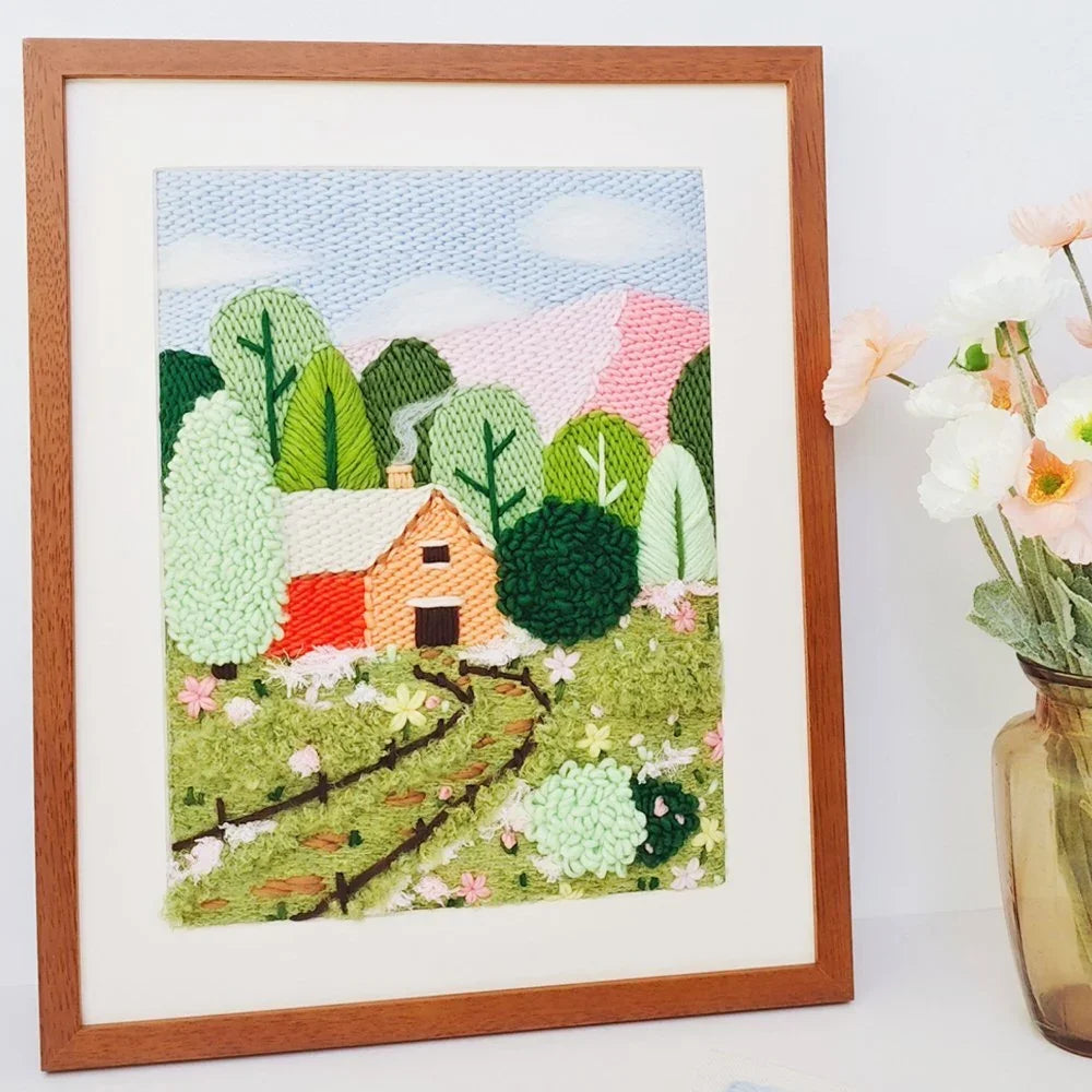 Cabin in the Woods DIY punch needle embroidery kit with framed landscape art.