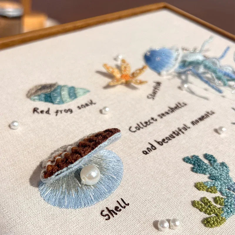 Ocean DIY fabric embroidery kit featuring seashells, starfish, and coral designs.