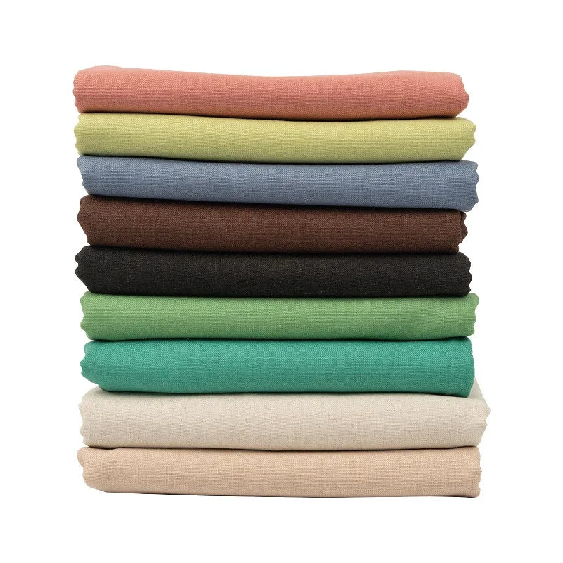 Stack of colorful cotton linen embroidery fabric in various shades