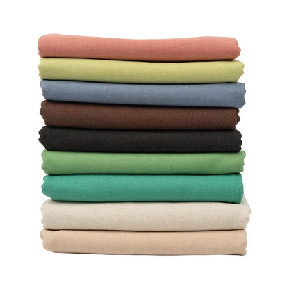 Stack of colorful cotton linen embroidery fabric in various shades