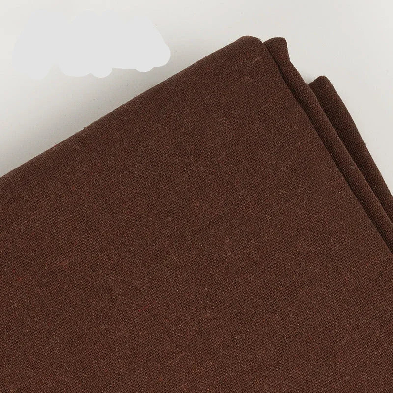 Close-up texture of brown cotton linen embroidery fabric by Calivra Craft.