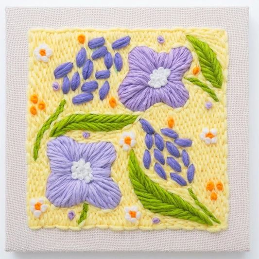 Calivra Craft DIY punch needle embroidery kit featuring purple flowers and green leaves.