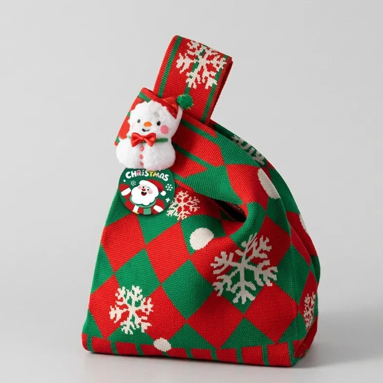 Red and green checkered Christmas knitted gift bag with snowman ornament and snowflake pattern.