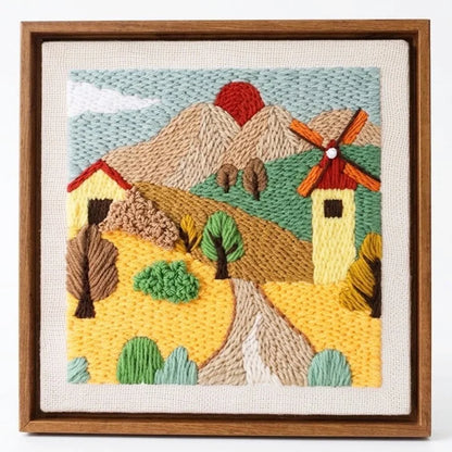 Calivra Craft DIY punch needle embroidery kit depicting a scenic landscape with a windmill