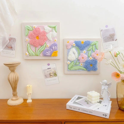 Calivra Craft DIY punch needle embroidery kits featuring colorful floral designs on a desk.