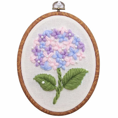 Flower DIY punch needle embroidery kit featuring a pastel hydrangea in a wooden hoop.