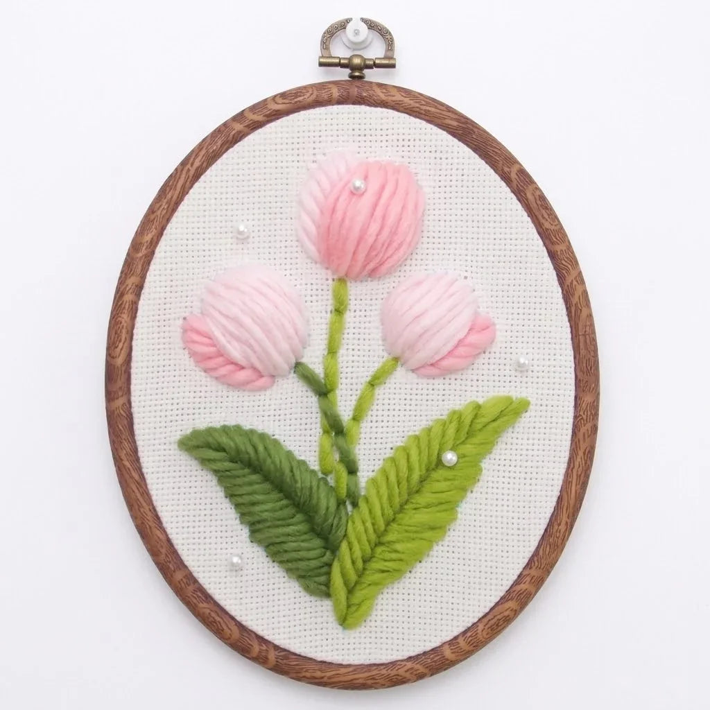 Pink flower punch needle embroidery kit by Calivra Craft in a wooden hoop.