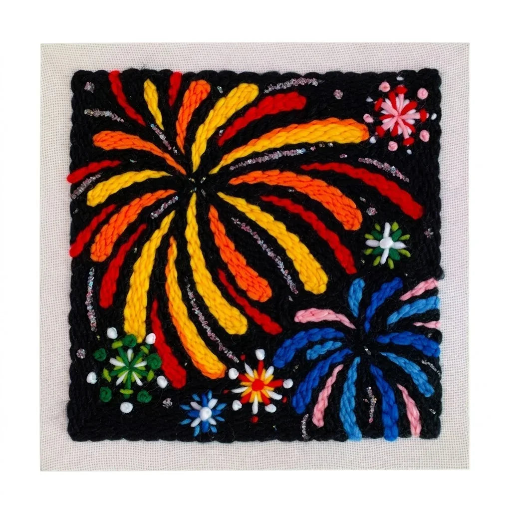Bright fireworks DIY punch needle kit by Calivra Craft featuring colorful yarn patterns.