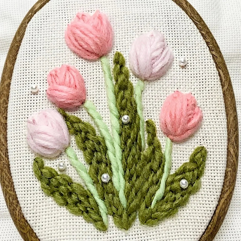 Pink tulip punch needle embroidery kit with green leaves and white pearl accents.