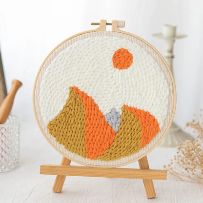 Embroidery hoop with a knitted fox design on a white background