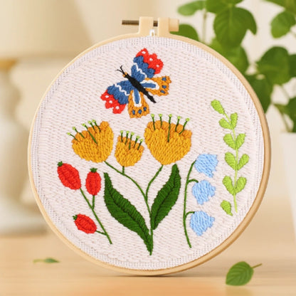This embroidery design captures a lively scene of blooming yellow flowers and a colorful butterfly dancing above them. The rich mix of red, blue, green, and gold threads creates a vibrant, joyful look that celebrates the beauty of nature. Simple and beginner-friendly, it’s a delightful way to enjoy a relaxing craft moment or create a heartfelt handmade gift.