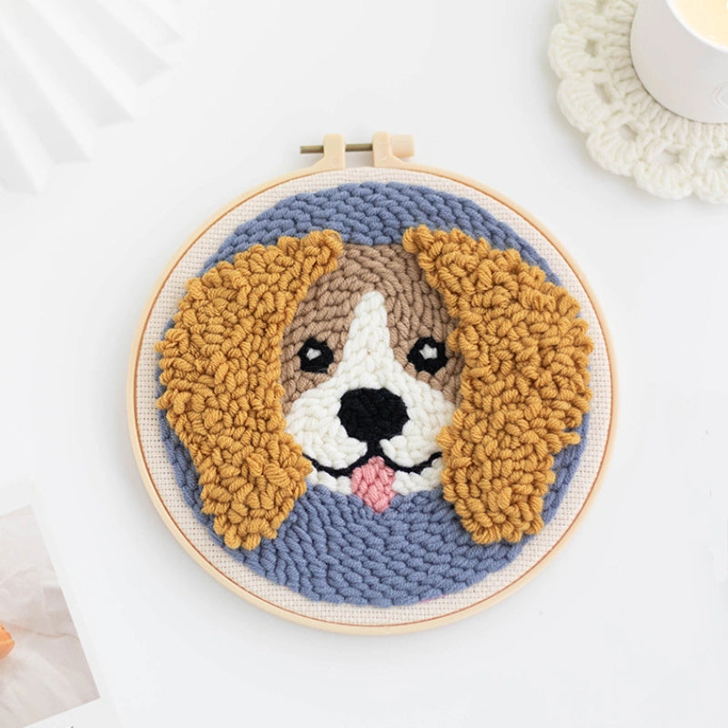 Punch Needle hoop with a dog face design on a white background
