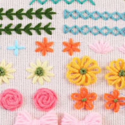 Combines wavy lines, small crosses, flowers, and bows in a variety of cheerful tones. A great way to master decorative stitches while creating charming and balanced designs.