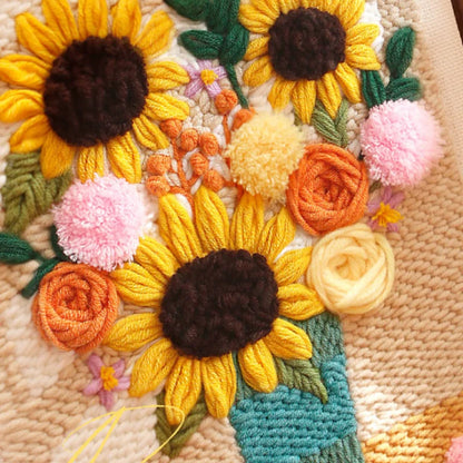 Embroidered floral design with sunflowers and roses on a textured fabric background