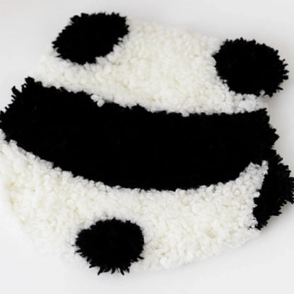 Panda-shaped decorative item made of white and black beads on a light gray background