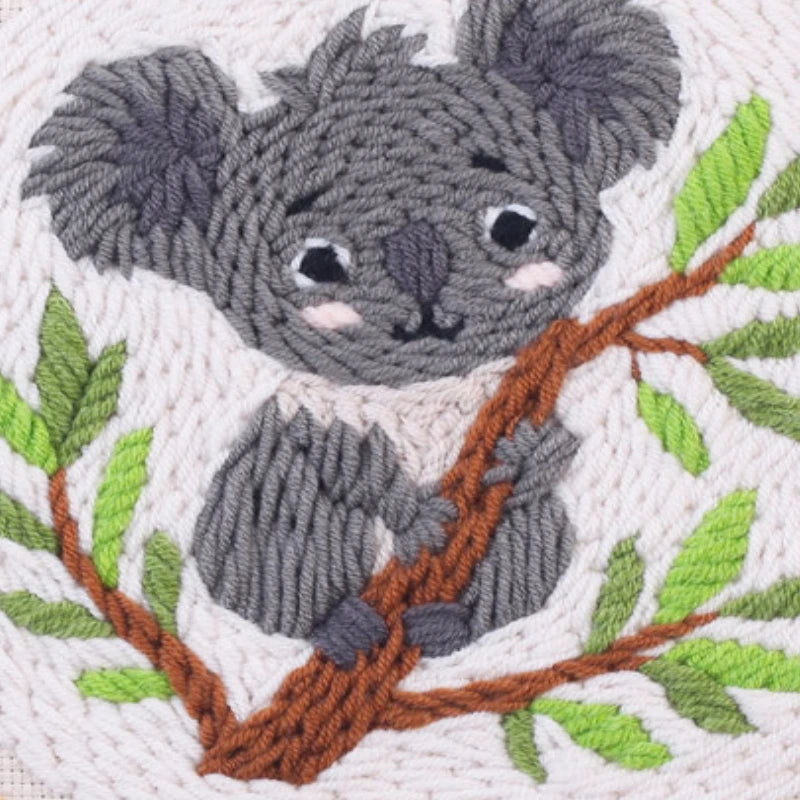 Embroidered koala on a branch with leaves