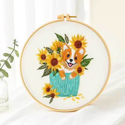 Embroidery hoop with a dog and sunflower design on a white background