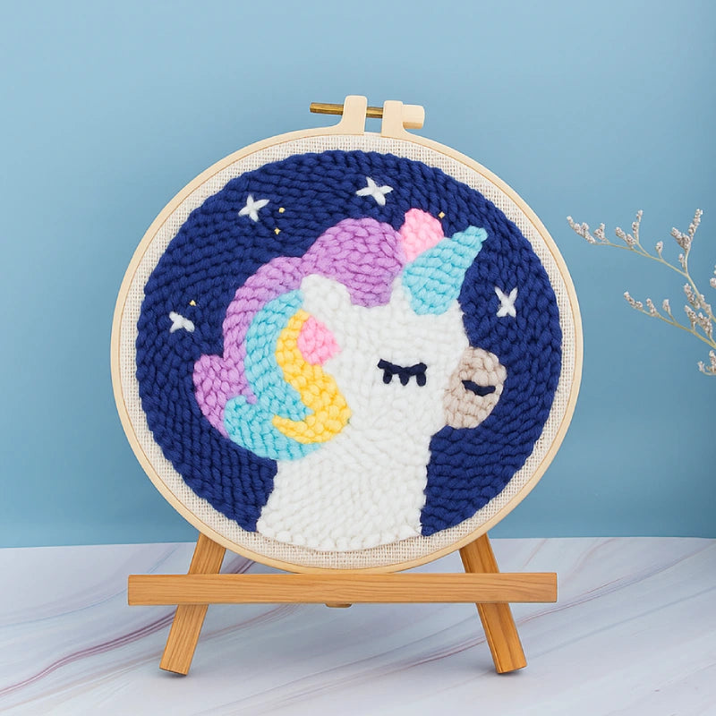 Embroidery hoop with a colorful unicorn design on a blue background