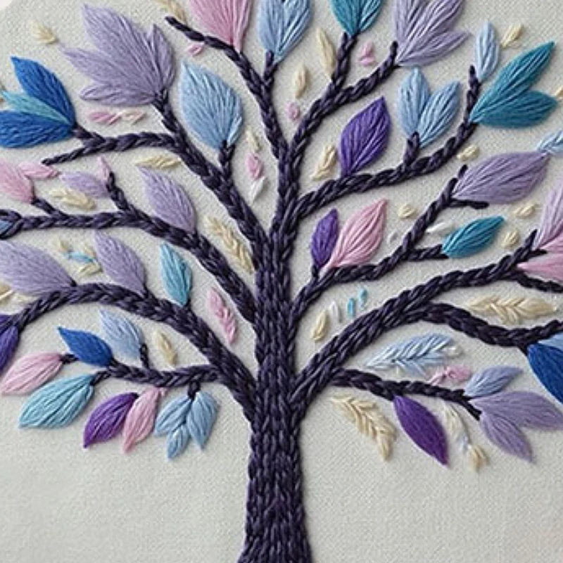 Embroidered tree design with colorful leaves on a white background