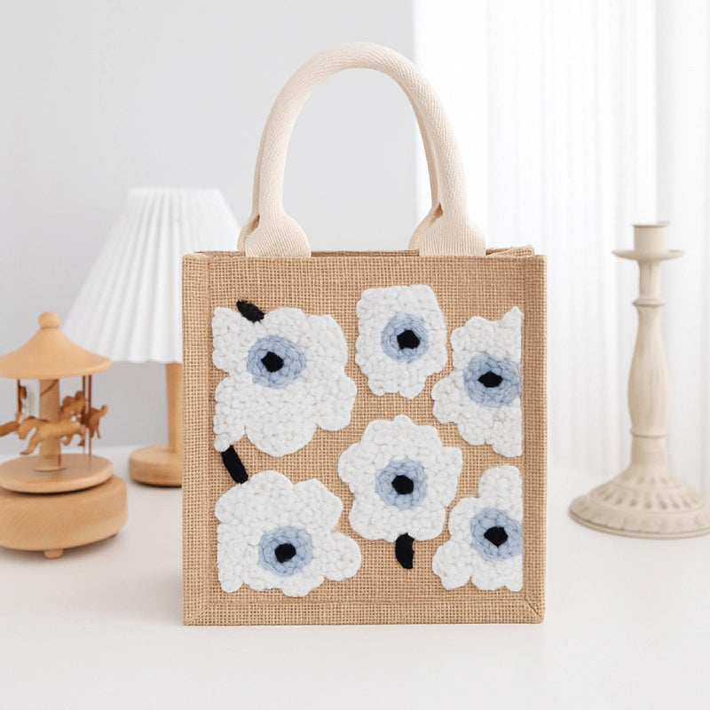 Jute bag with floral patterns on a white background