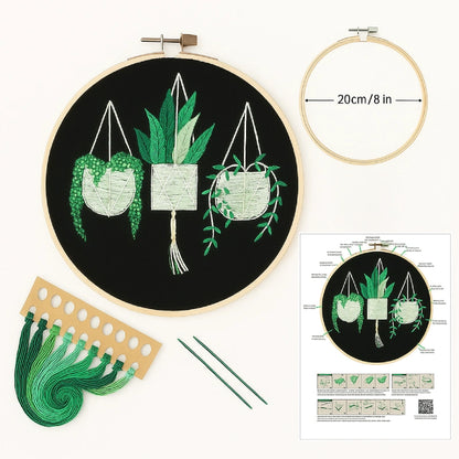 Embroidery hoop with pre-printed design, green thread, and instruction sheet on a white background