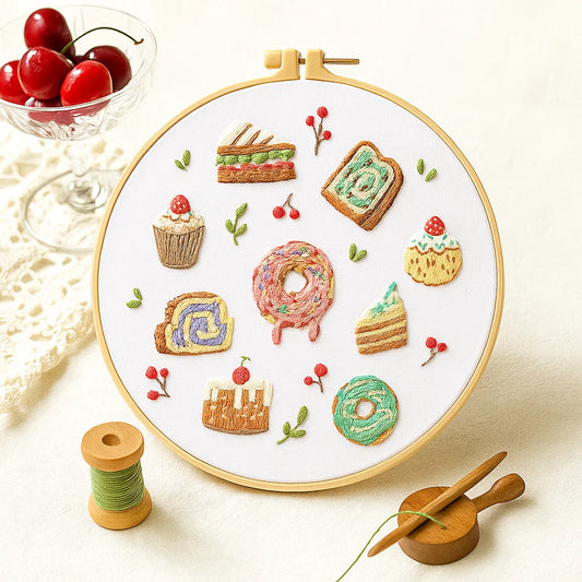 Embroidery hoop with colorful embroidered food patterns on a white background