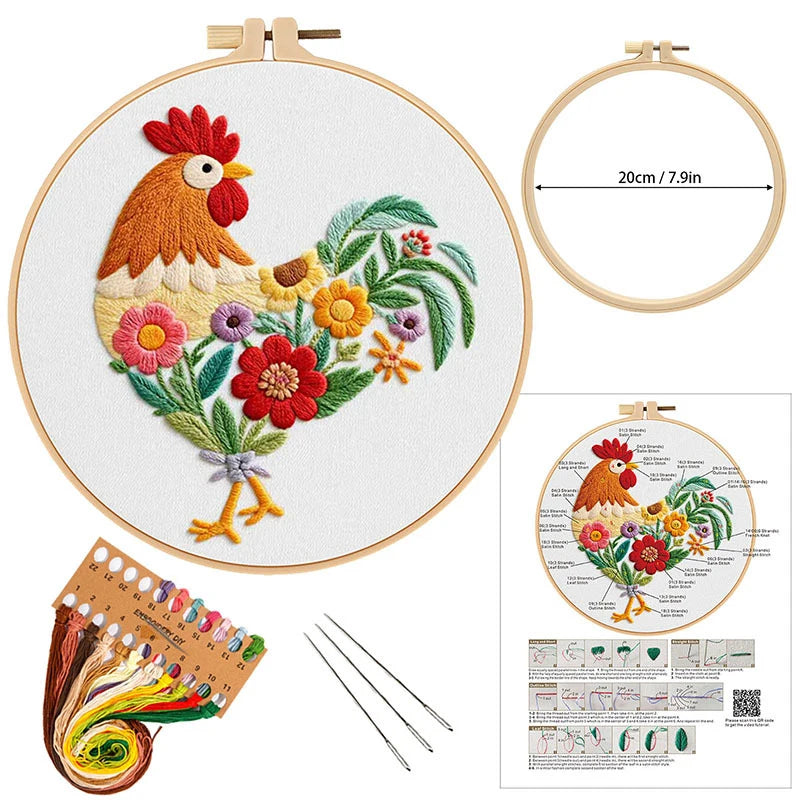 Embroidery kit with a rooster design, hoop, thread, needles, and pattern guide on a white background.