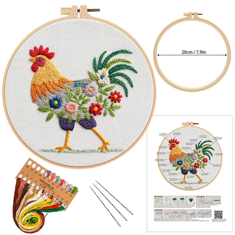 Embroidery kit with rooster design, hoop, threads, needles, and pattern guide on a white background.