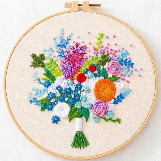 Handmade floral embroidery art with colorful flowers in a wooden hoop.