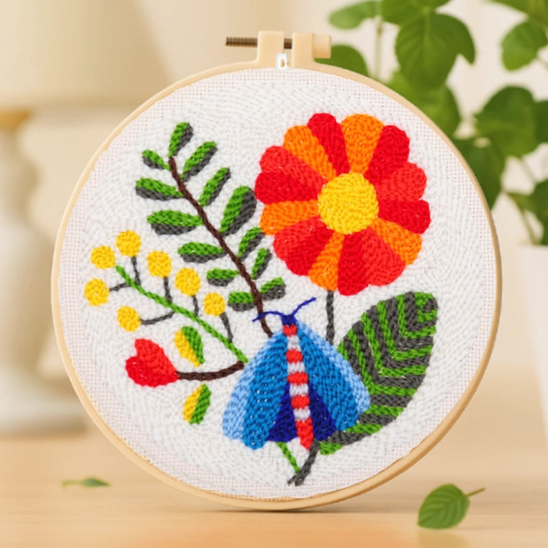 Vivid red and orange petals intertwine with lush green leaves, while a bright blue butterfly flutters gracefully among them. The lively color palette and playful composition bring the piece to life, radiating joy and the energy of a blooming garden.