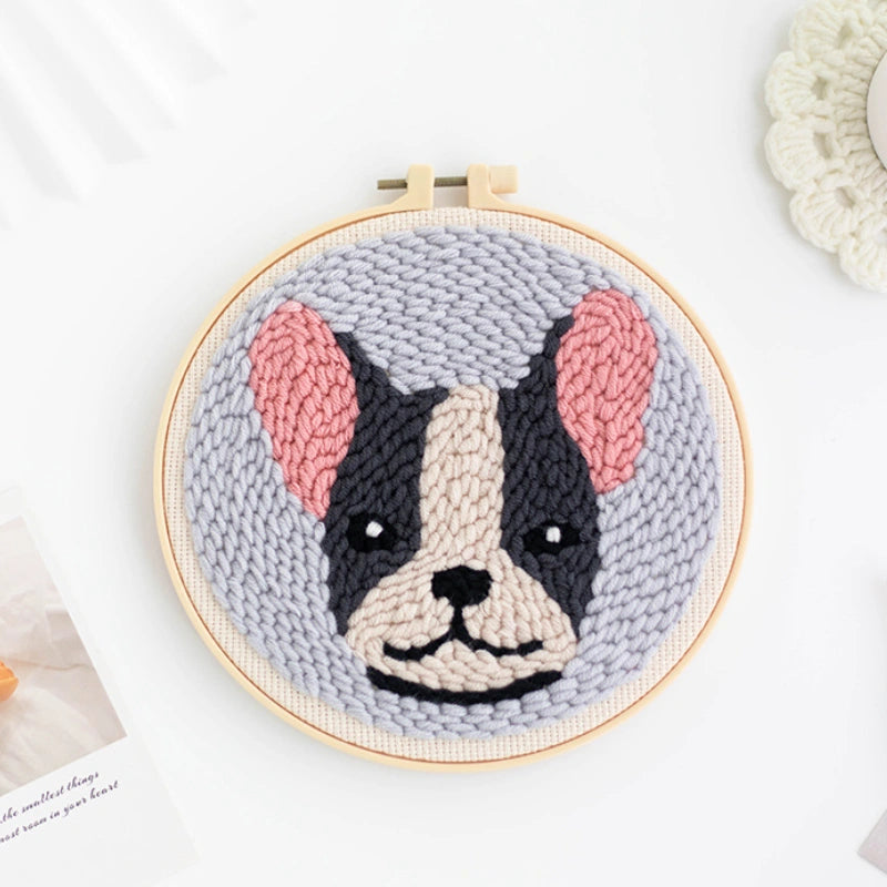 Punch Needle hoop with a knitted dog portrait on a white background