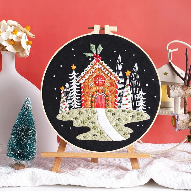 This embroidery design features a cozy gingerbread cottage surrounded by snowy trees and festive stars. The warm red tones and twinkling white snow create a charming winter scene that brings the magic of Christmas to life. Perfect for decorating your home or gifting to a loved one who adores handmade crafts.