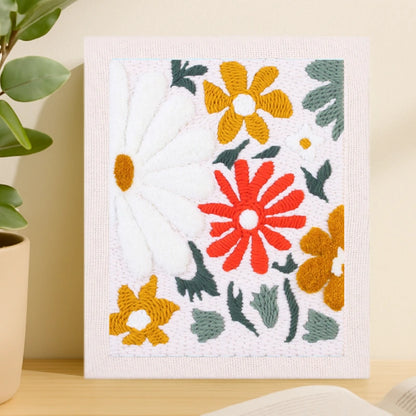 This design features bright red, white, and mustard-yellow flowers with soft green leaves, capturing the warmth and vibrance of a blooming summer field.