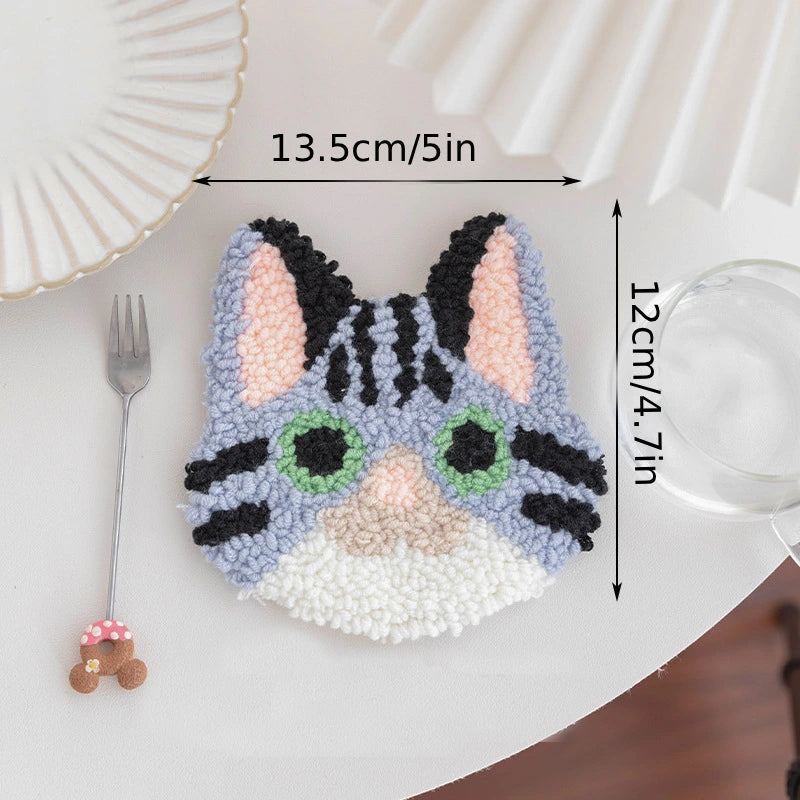 Cat-shaped decorative item with measurements on a white surface