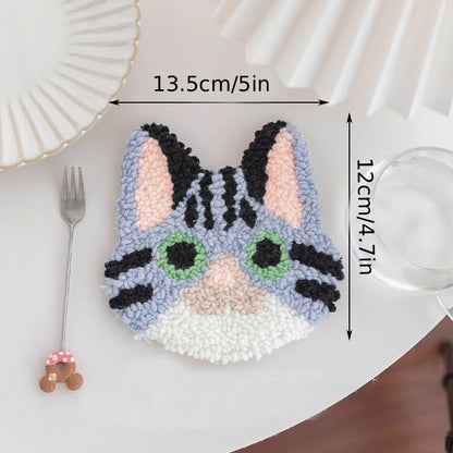 Cat-shaped decorative item with measurements on a white surface
