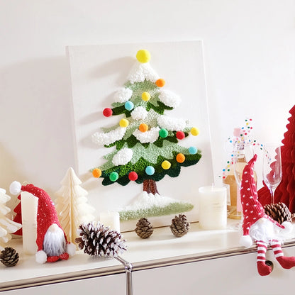 Decorative Christmas scene with a tree, gnomes, and pinecones on a white surface.