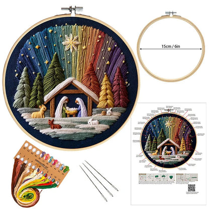 Embroidery hoop with a colorful nativity scene design, including an embroidery kit and instructions.