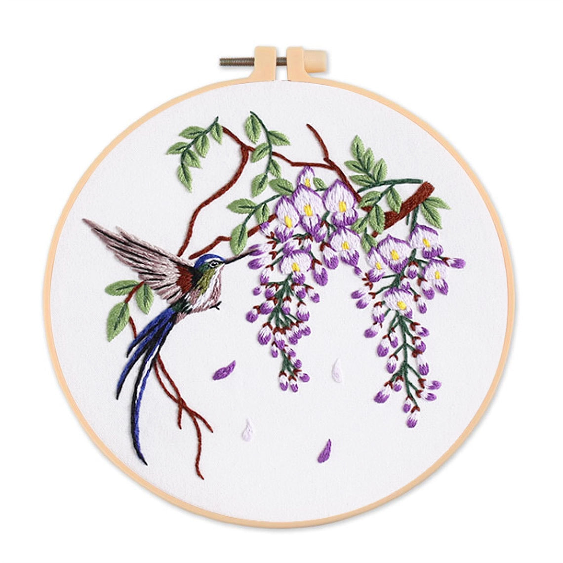 Embroidery hoop with a hummingbird and wisteria branch design on a white background
