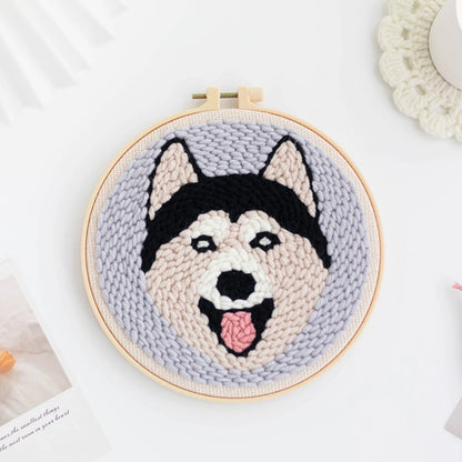 Punch Needle hoop with a dog's face design on a light background