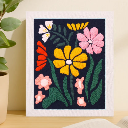 This design features vivid flowers in yellow, pink, red, and white blooming against a deep navy background, creating a striking and elegant contrast.