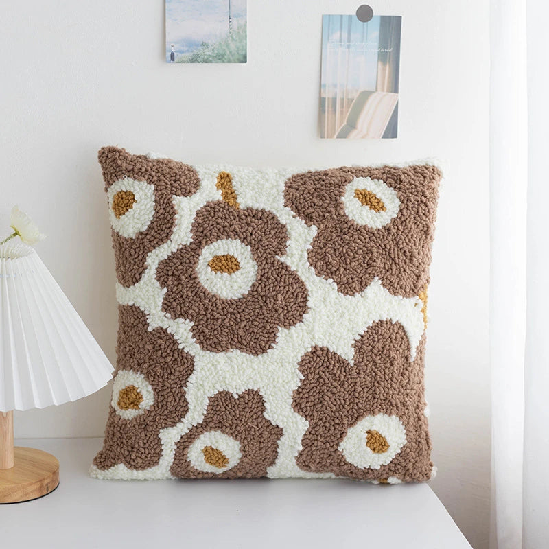 A cozy punch needle pillow cover featuring mocha brown flowers with soft cream petals. Its warm, earthy tones bring a natural and comforting vibe to your living space.