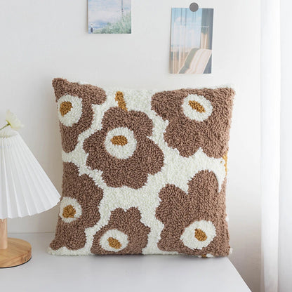 A cozy punch needle pillow cover featuring mocha brown flowers with soft cream petals. Its warm, earthy tones bring a natural and comforting vibe to your living space.