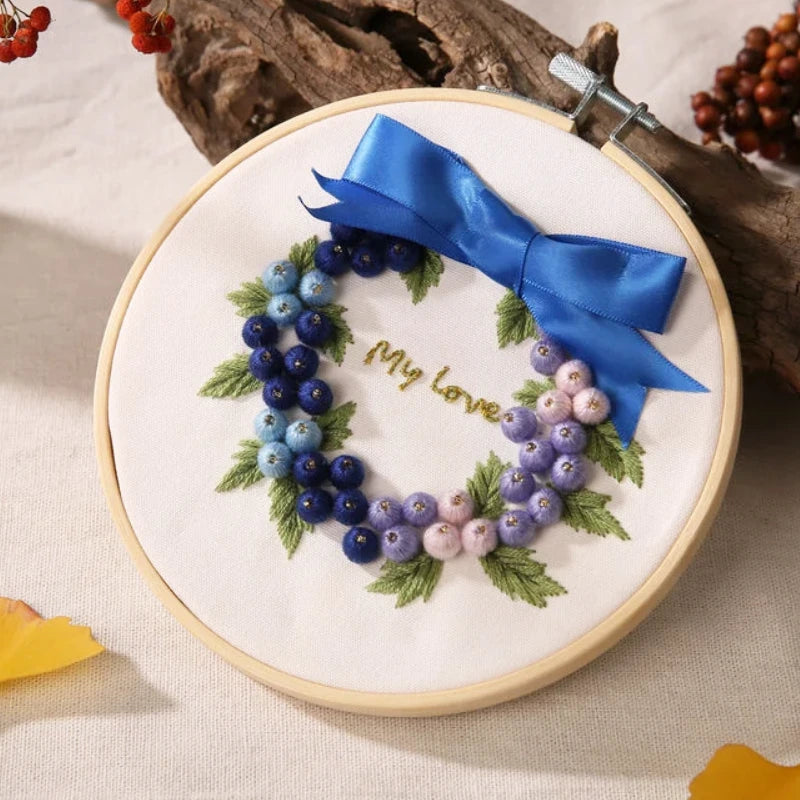 Elegant and calming, the Blueberry Dream Wreath design captures the gentle beauty of love and serenity.
Shades of blue and lilac blend harmoniously to form a soft, romantic wreath, adorned with a satin blue bow. It’s a perfect piece to express affection, decorate your home, or gift to someone special.