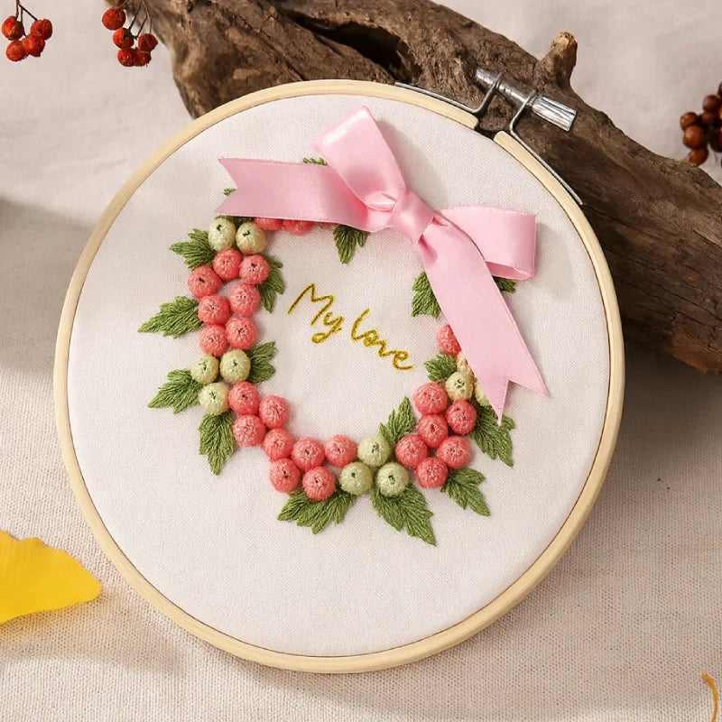 A tender expression of love in soft pink hues.
This My Love – Pink Blossom Wreath design features delicate pastel berries and lush green leaves, crowned with a gentle satin bow. Perfect for those who adore feminine elegance, this embroidery radiates warmth and affection — an ideal handmade gift for someone special.