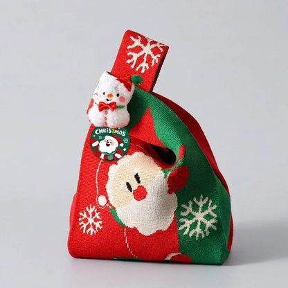 Red and green knitted Christmas gift bag with Santa Claus and snowflake patterns.