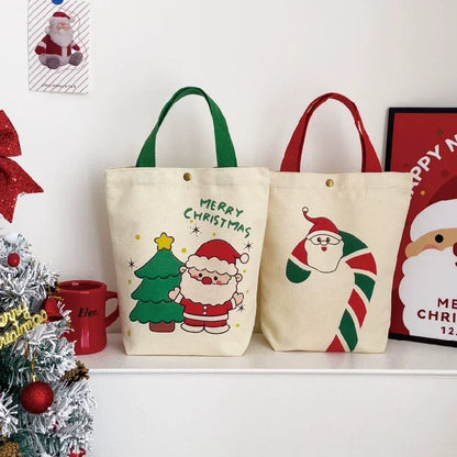 Two Christmas canvas gift bags with Santa and candy cane designs on a white shelf.