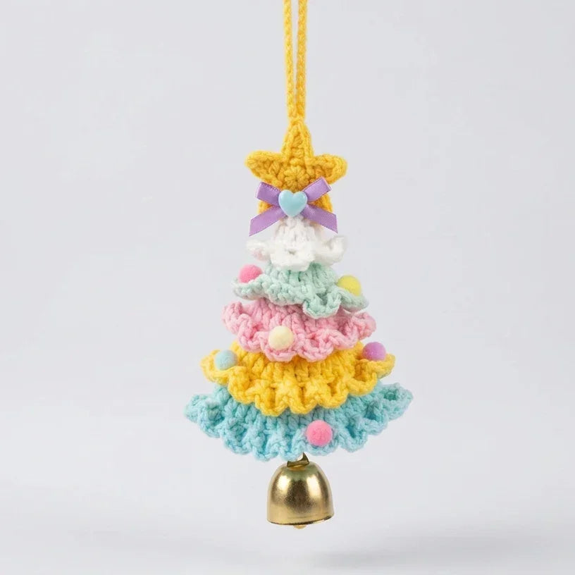 Handmade colorful knitted Christmas tree ornament with a gold bell and star topper.